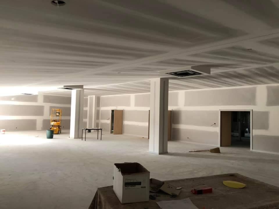 Large open commercial space with new plasterboard walls, ceiling and columns
